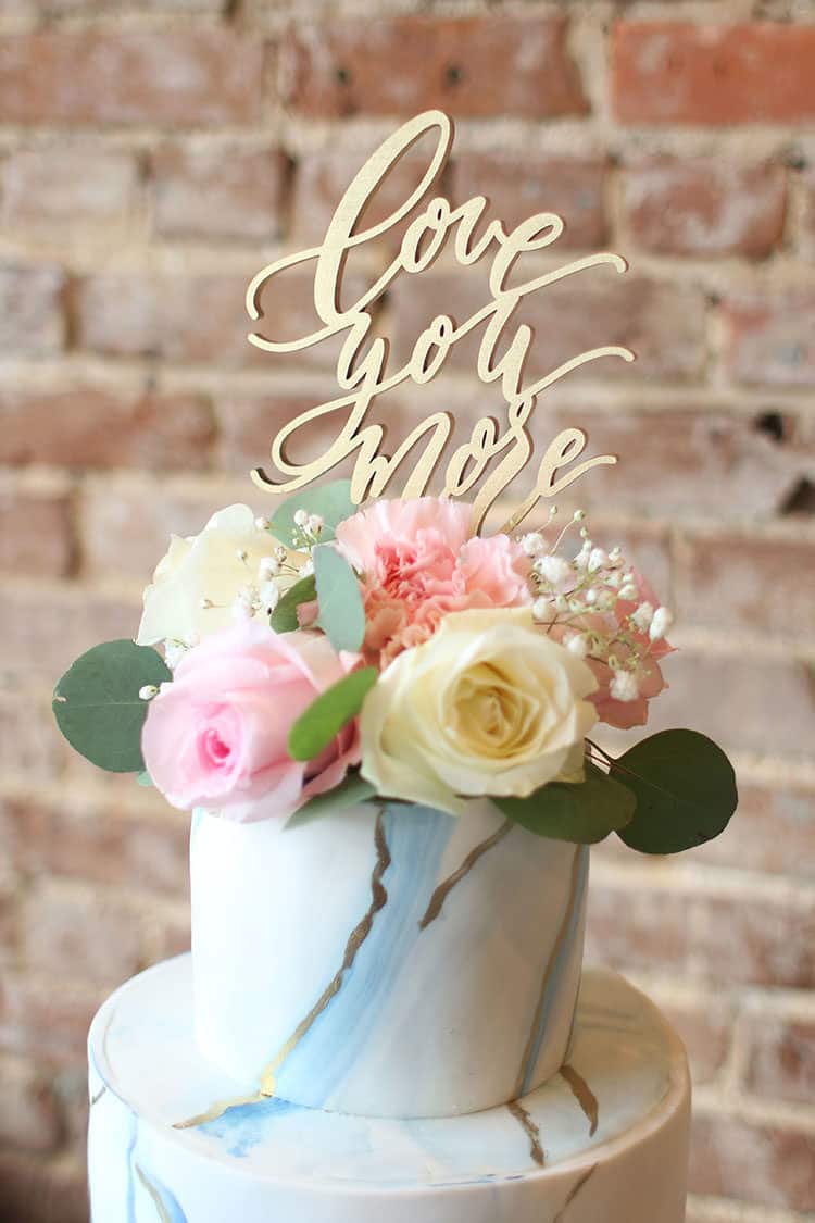 Marbled Fondant Wedding Cake with Navy, Gold and Pink with "Love You More" cake topper and flowers