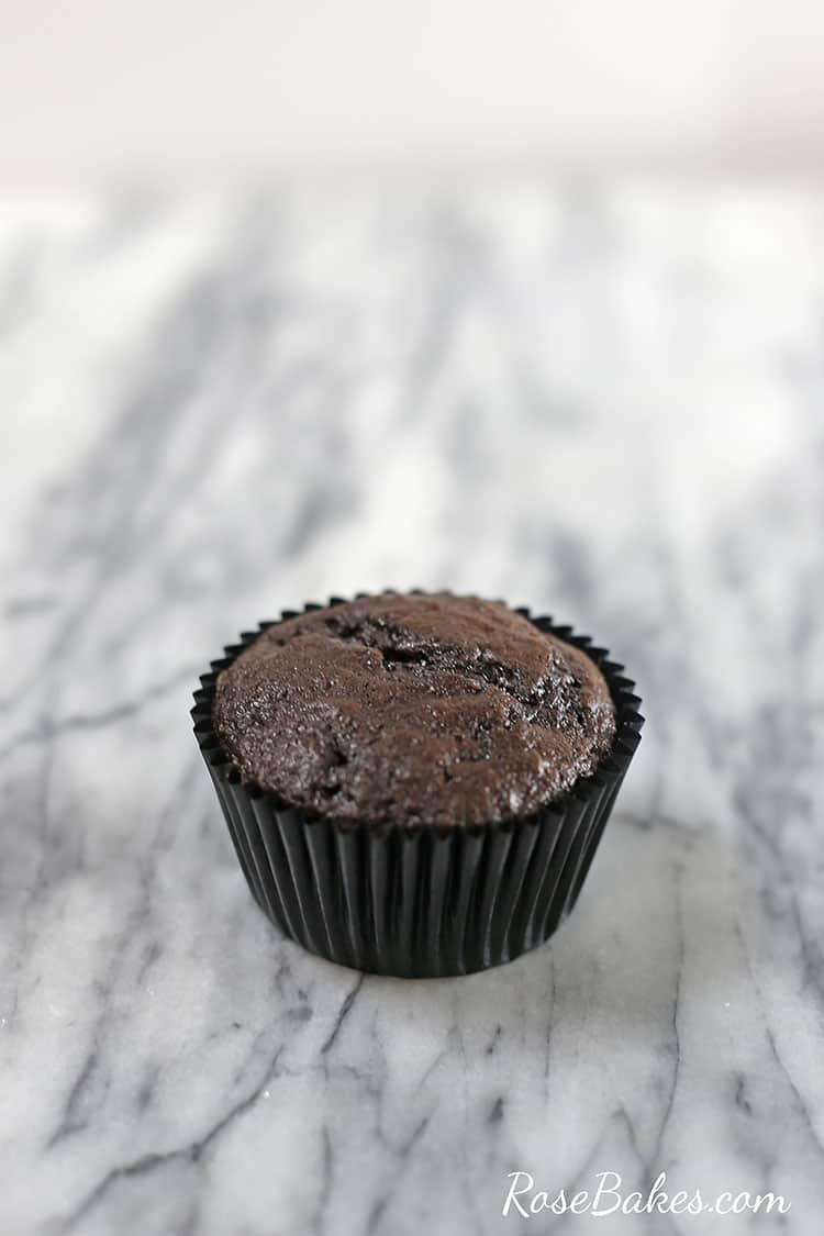 chocolate cupcake in a liner on a counter