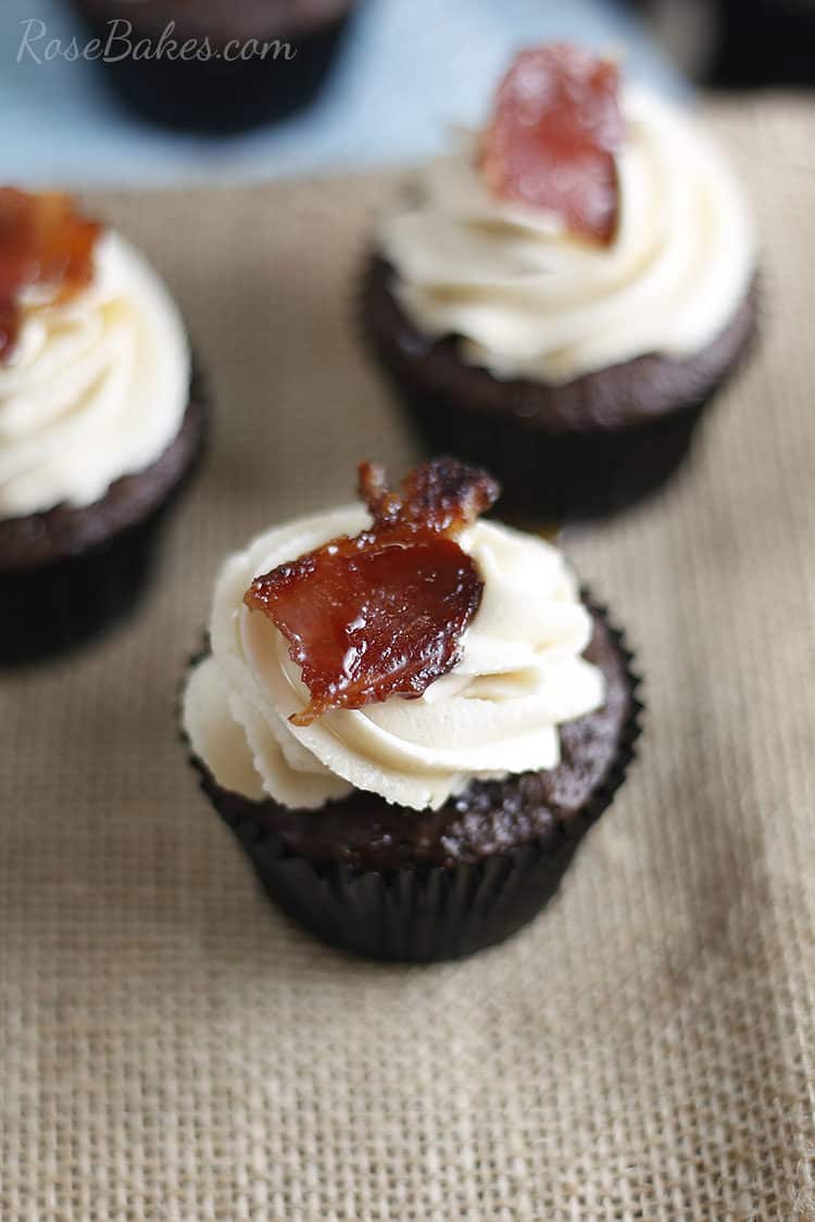 chocolate cupcake with maple buttercream icing with bacon piece on top