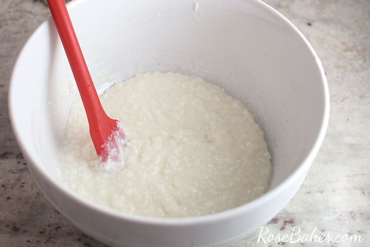 white mixing bowl with coconut syrup ingredeints in a bowl - mixed together