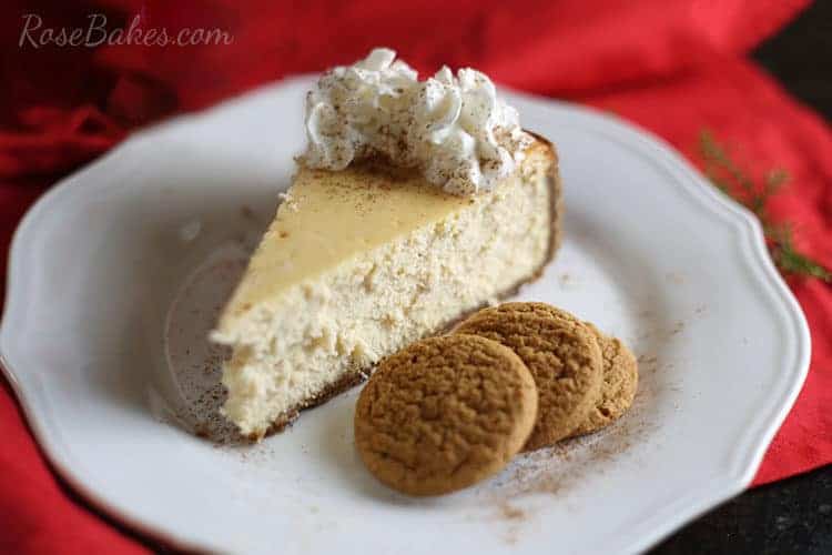 Eggnog Cheesecake with Gingersnap Crust on white plate with red backround