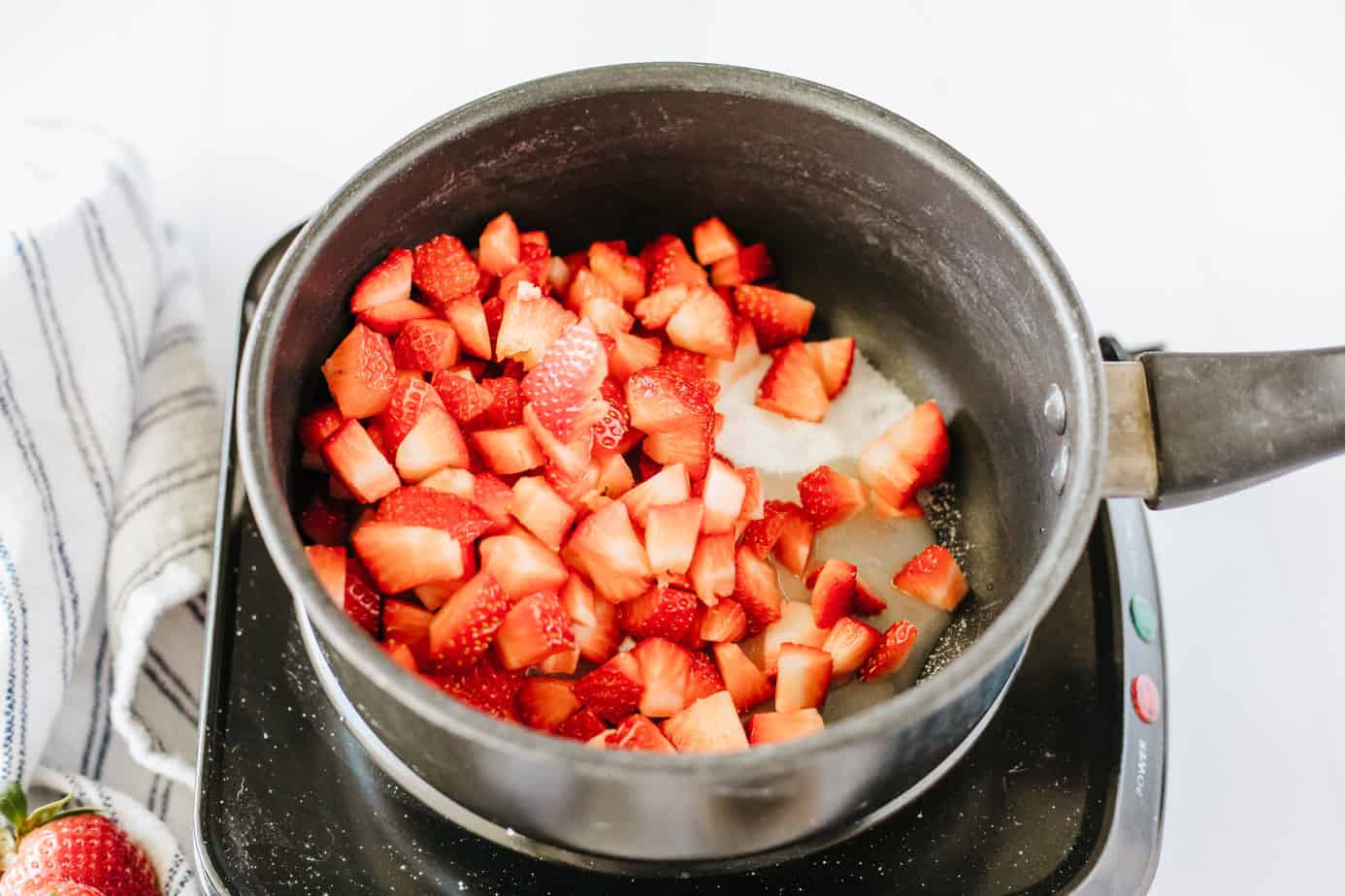 diced strawberries, sugar, lemon juice, vanilla  in a boiler on a electric cooktop