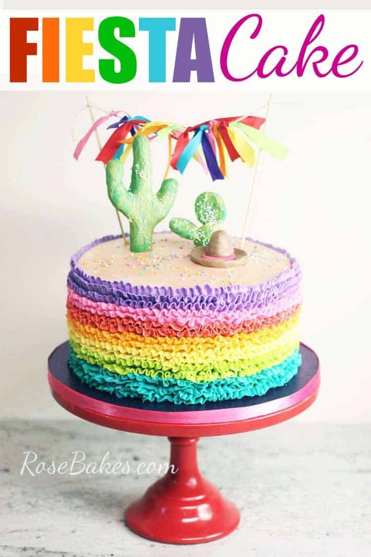 rainbow ruffles buttercream fiesta cake on red cake stand with pinterest text
