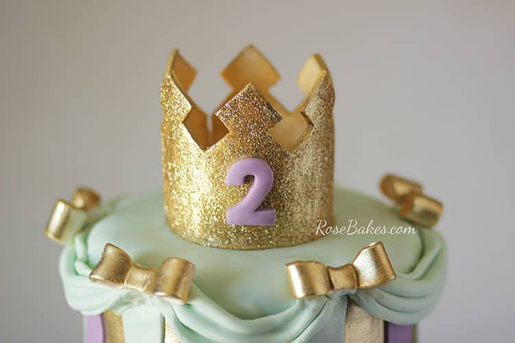 glittery gold crown on princess cake