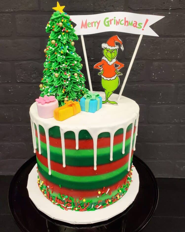 2 tier grinch cake with white drip icing top by Sweet Revenge Bake Shop
