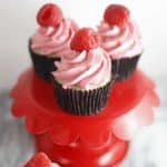 Raspberry Buttercream cupcakes on a red cupcake stand