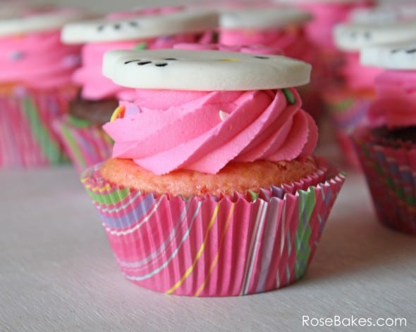 Side view of a cupcake with a Hello Kitty Cupcake Topper and Snappy Stripes baking cups