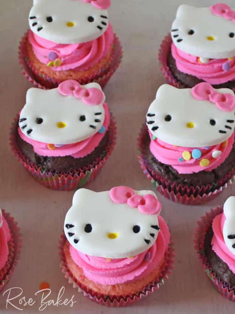 fondant Hello Kitty Cupcake Toppers on cupcakes with pink frosting and sprinkles