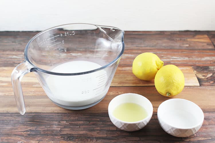 cup of milk with lemons and white vinegar in small white bowls