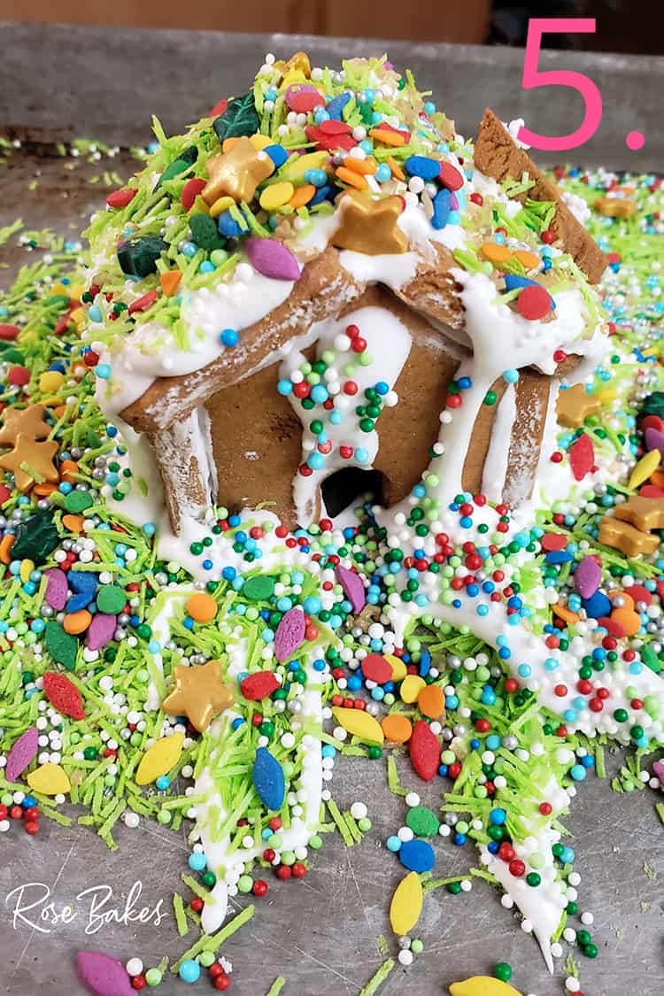 Mini gingerbread house with lots and lots of sprinkles and decorations done by a kid