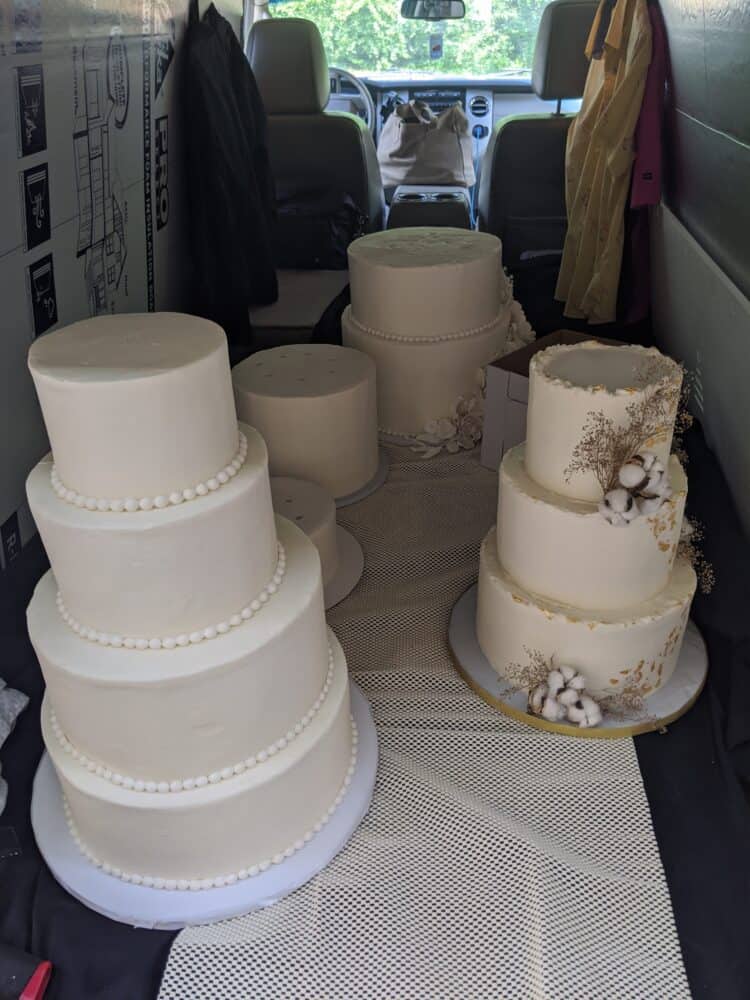 multiple cake tiers seperated in back of vehicle for transport 