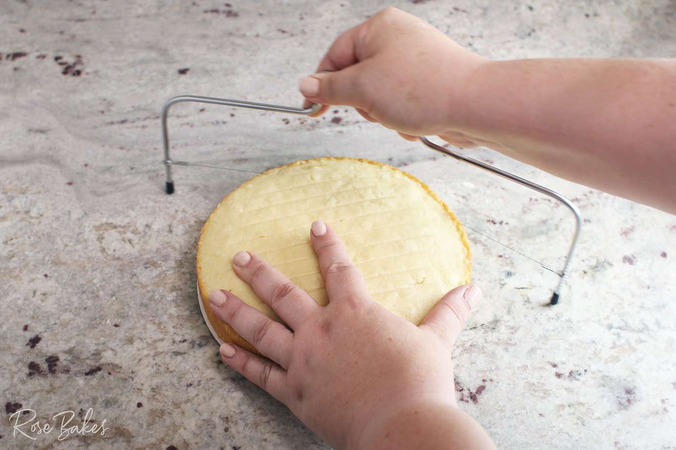 cutting the dome off a cake with a cake leveler