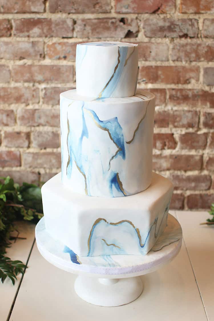 Marbled Fondant Wedding Cake with Navy, Gold and Pink before the flowers were added. on a white cake stand