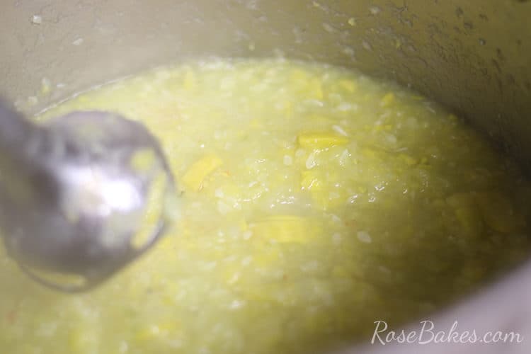 stick blender in pot of cooked squash
