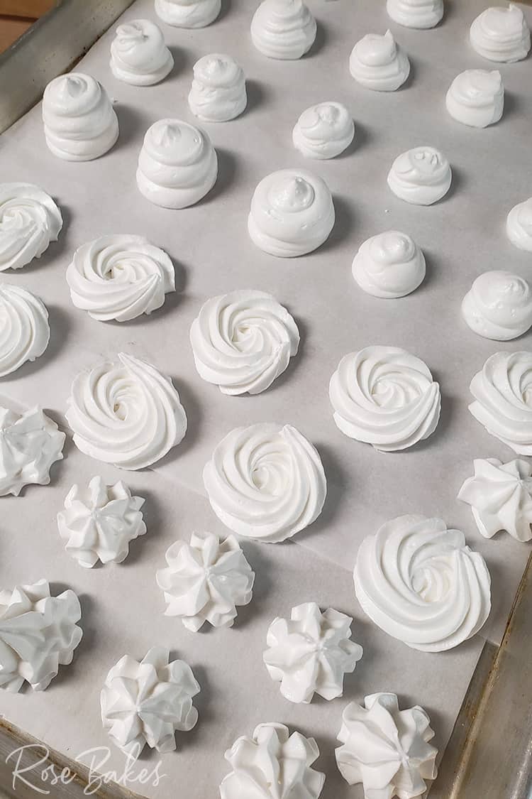 Easy Meringue Cookies piped onto aparchment paper lined cookie sheet before baking.