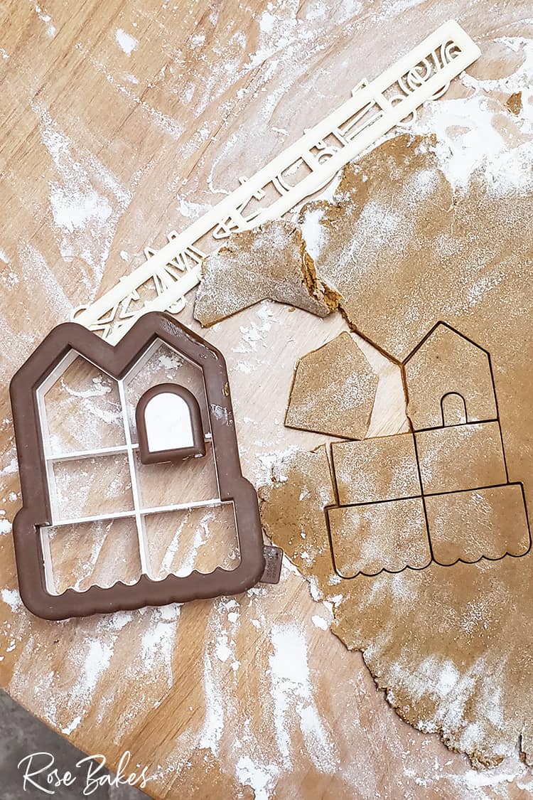 Mini Gingerbread House Cookie Cutter next to Gingerbread dough cut out with cutter