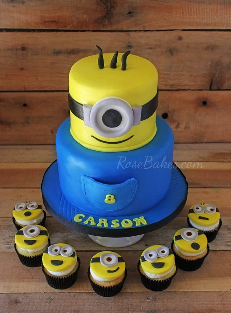 minion cake with cupcakes around bottom