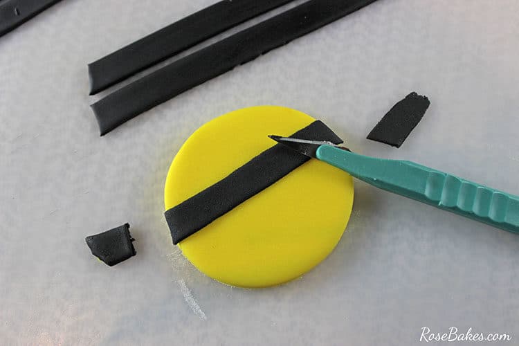 round yellow fondant area with black fondant strip placed on top 