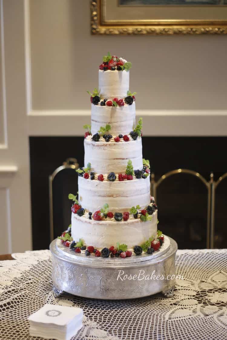 Semi Naked Wedding Cake with Fresh Fruit and Greenery on Silver Stand 