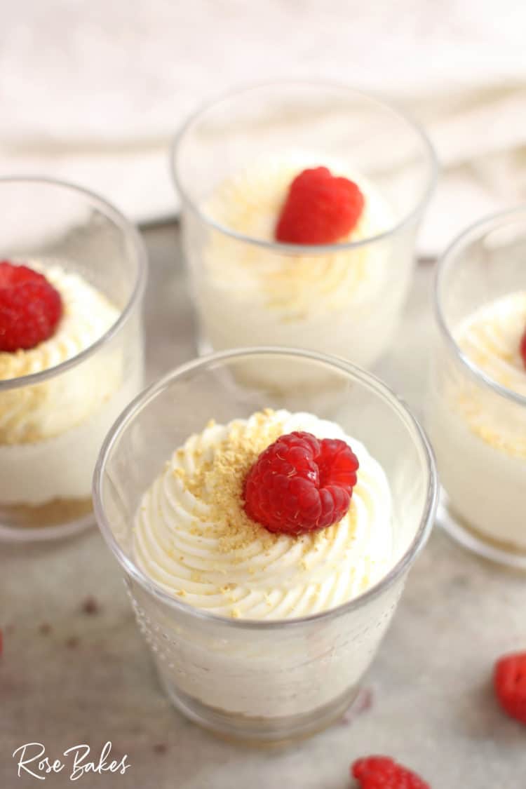 No-Bake Cheesecake Cups Recipe in cups with raspberries on top 