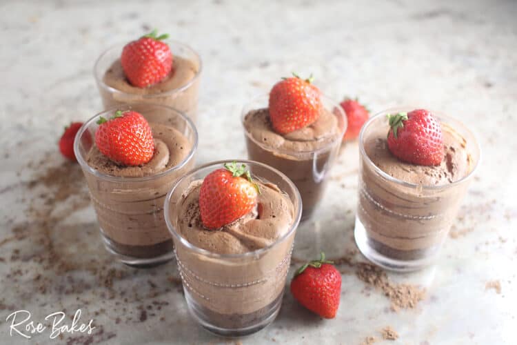 Creamy No-Bake Chocolate Cheesecake Cup Recipe - small glasses with strawberries on top ona  counter