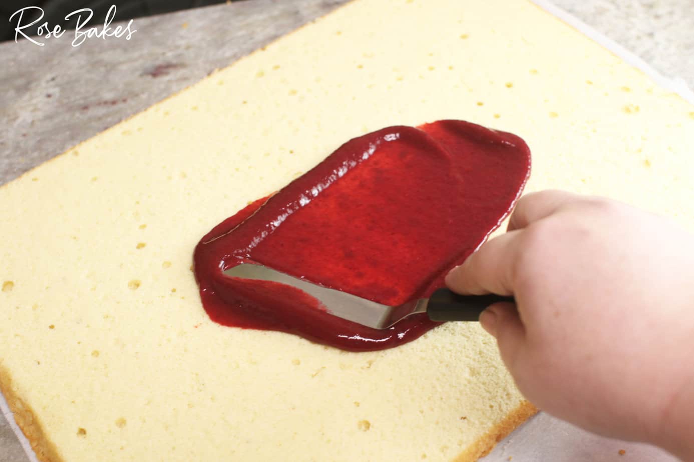 raspberry filling being added to the cake