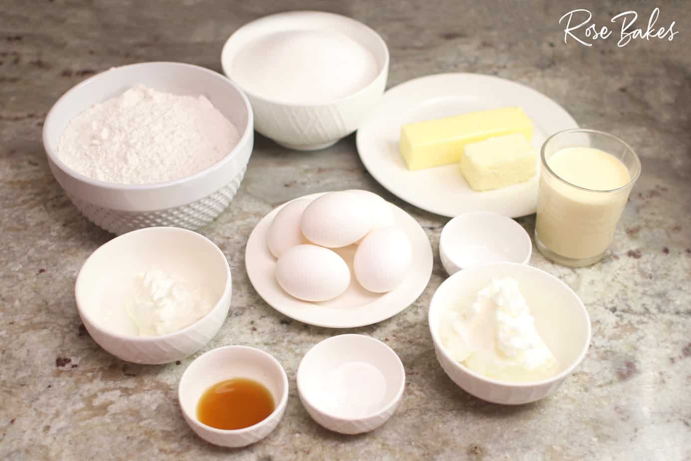 Ingredients portioned out in white dishes to make vanilla petit fours