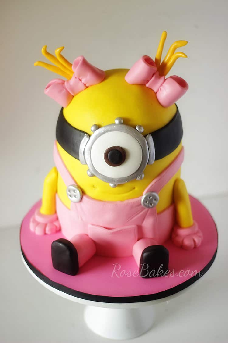 little girl minion cake with pink overalls