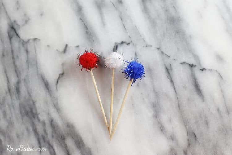 red white and blue pompoms on toothpicks