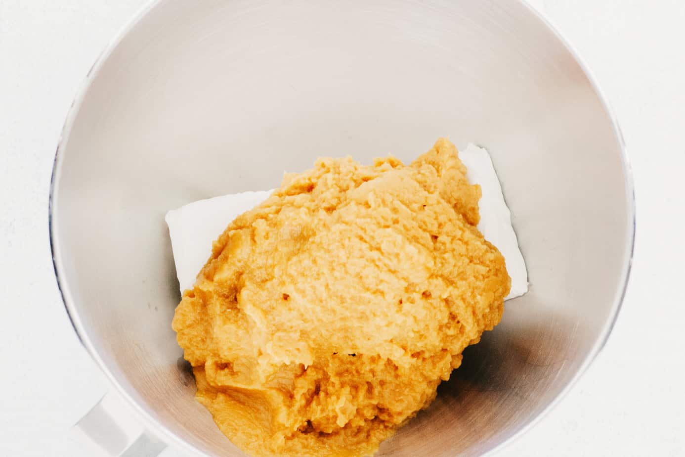cream cheese and pumpkin pie mix in a mixing bowl