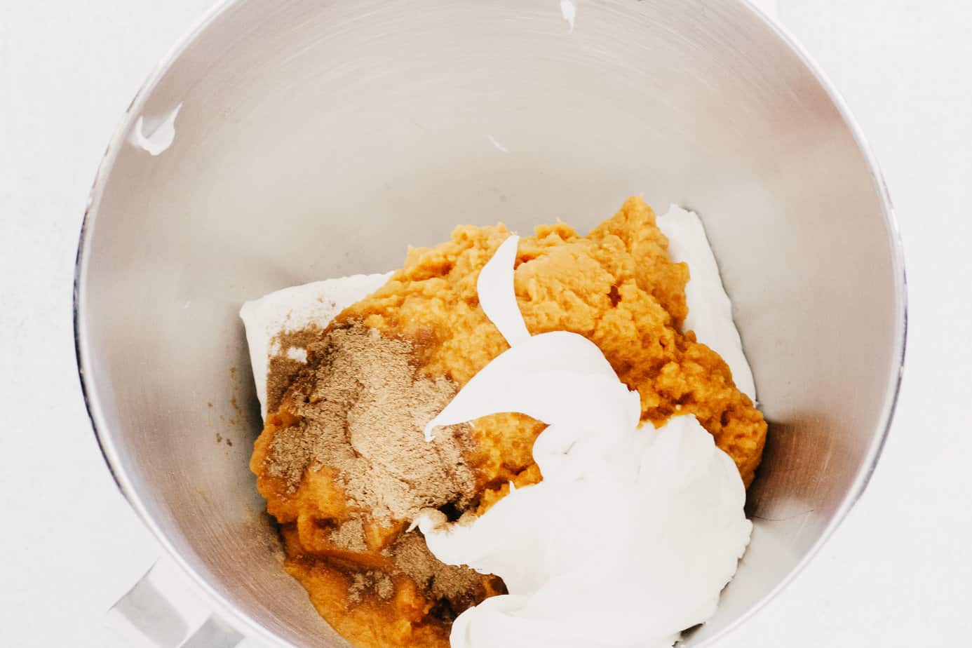 cream cheese, pumpkin pie spice, cool whip, and pumpkin pie mix in a mixing bowl