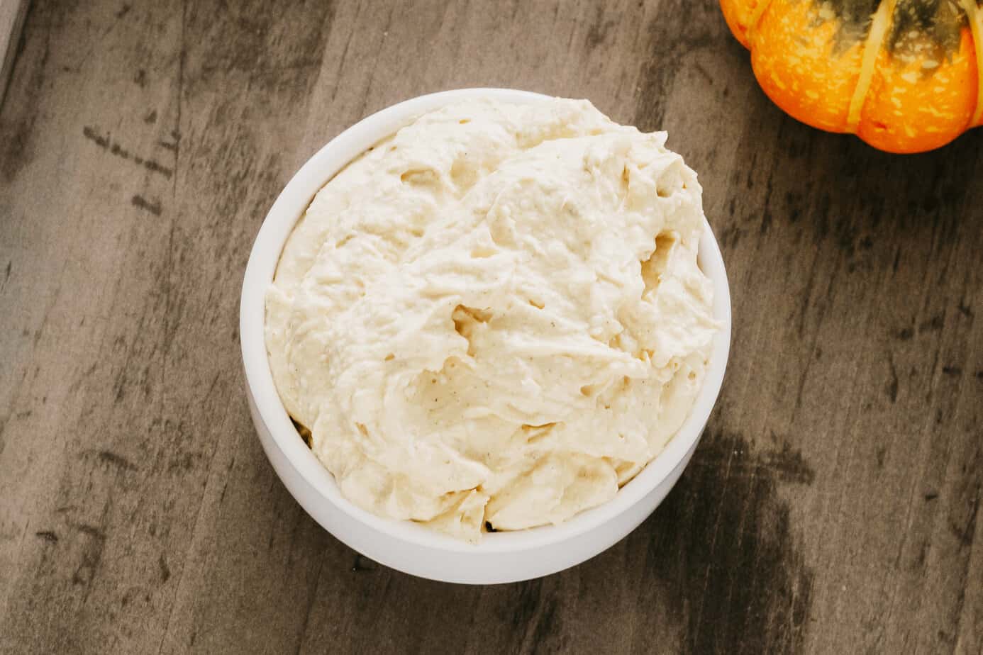 pumpkin cream cheese dip in a white bowl
