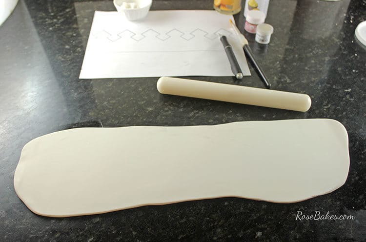 Rolling out gum paste for crown cake topper