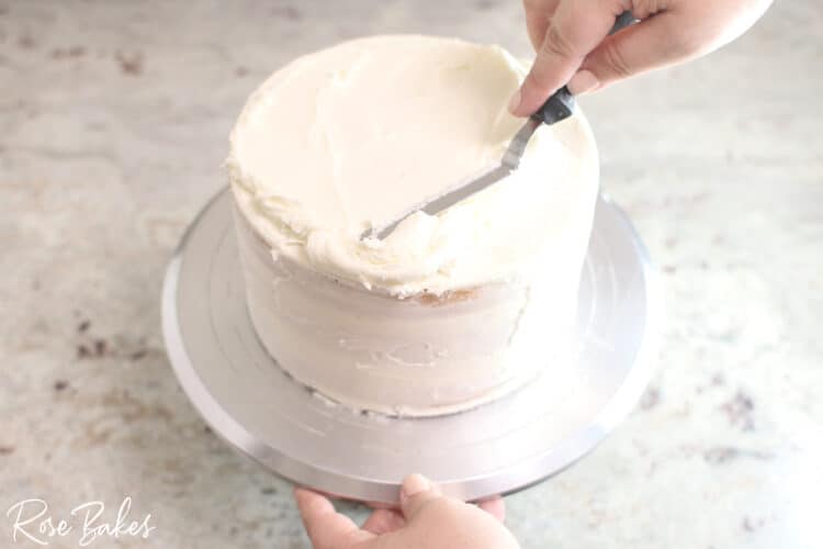 buttercream icing being spread with offset spatula 