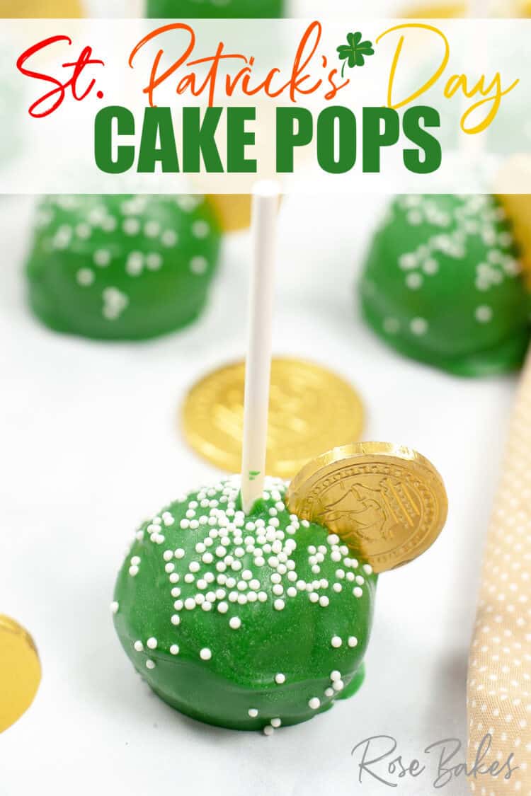 Green cake pop with white nonpareil sprinkles and a gold coin on top.