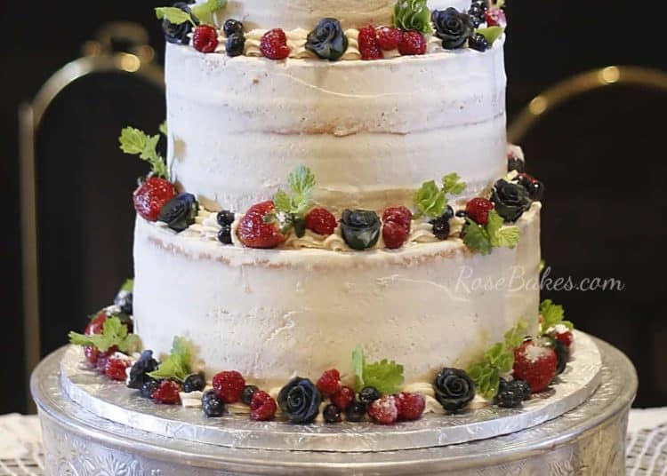 Close up Semi Naked Wedding Cake with Fresh Fruit and Greenery