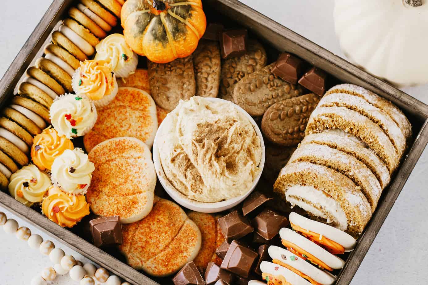 Thanksgiving Dessert Charcuterie Board filled with pumpkin dip, cookies, cakes, and candies