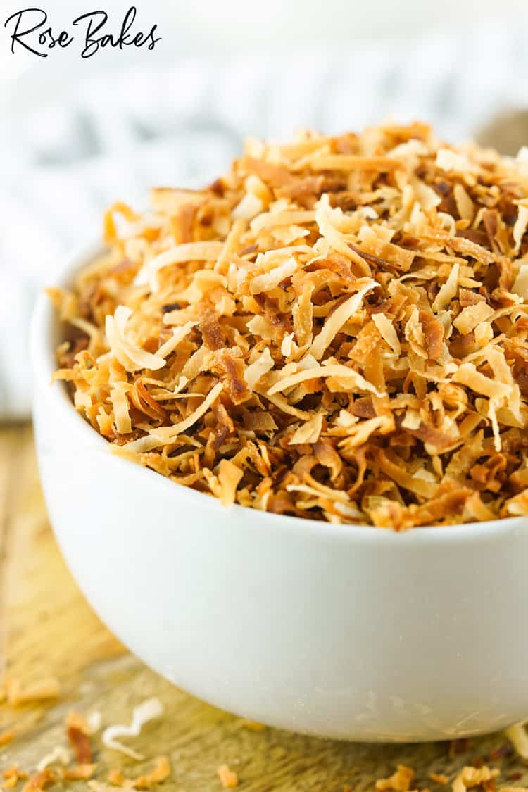 A white bowl filled with toasted coconut