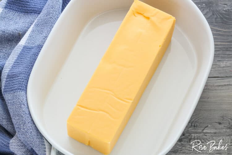 white serving dish with velveeta cheese inside 