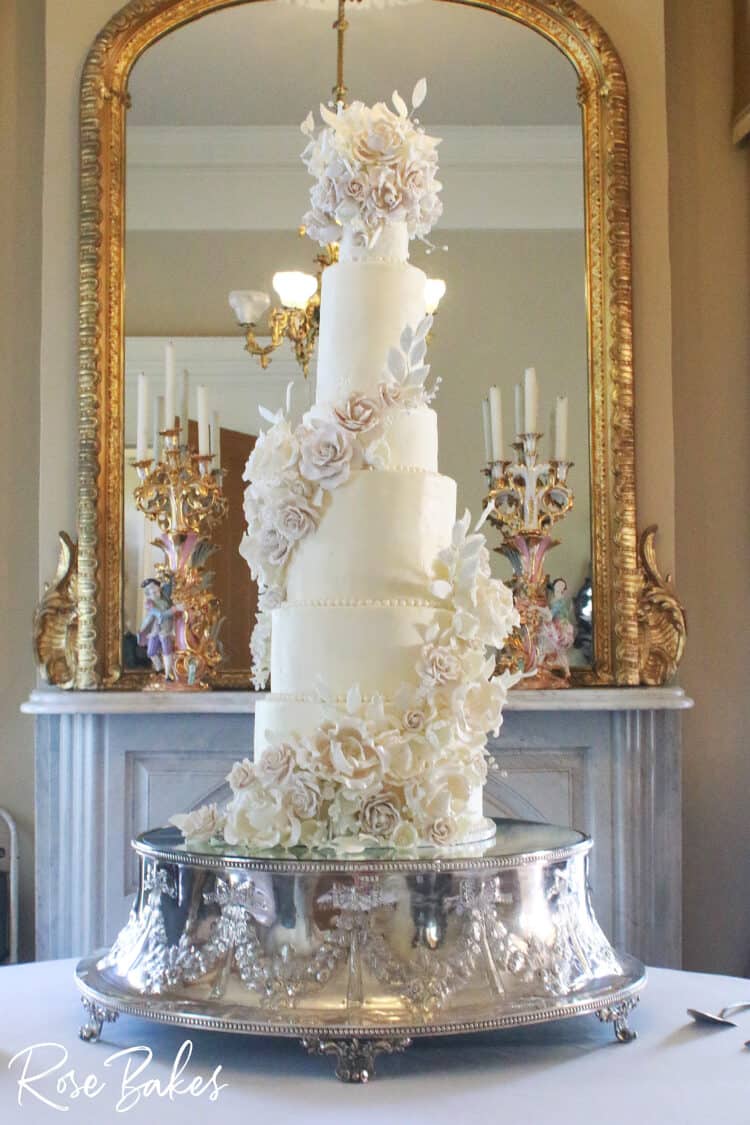 Tall Elegant Luxury wedding cake 9 tiers on silver cake stand with white sugar flowers 