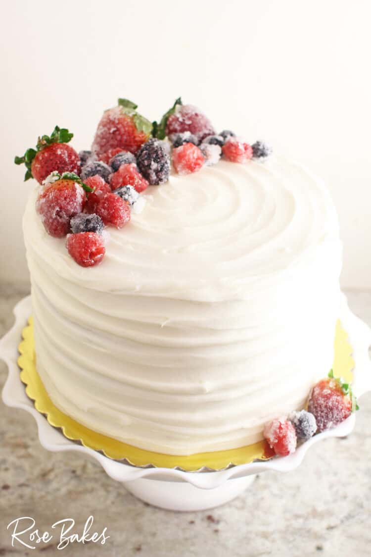 Chantilly cake with textured buttercream and topped with sugared berries.