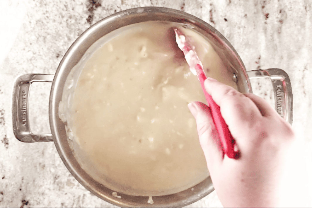 mixing cream cheese into potato soup 
